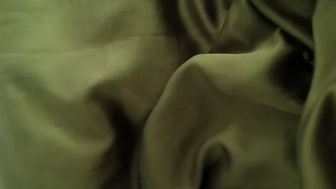 Closeup video of hands touching soft green silk fabric Stock Footage 317094099