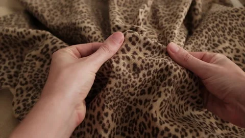 Closeup video of hands touching soft woolen leopard print fabric. Stock-Footage 317094129