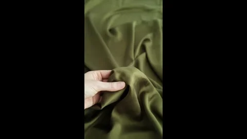 Closeup video of hands touching soft green silk fabric Stock Footage 317094276