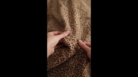 Closeup video of hands touching soft woolen leopard print fabric. Stock Footage 317094281