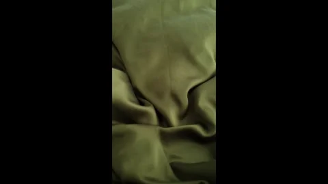 Closeup video of hands touching soft green silk fabric Stock Footage 317094287