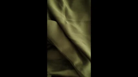 Closeup video of hands touching soft green silk fabric Stock Footage 317094299