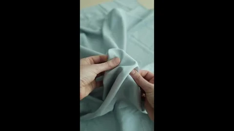 Closeup video of hands touching soft blue silk fabric. Stock Footage 317094305
