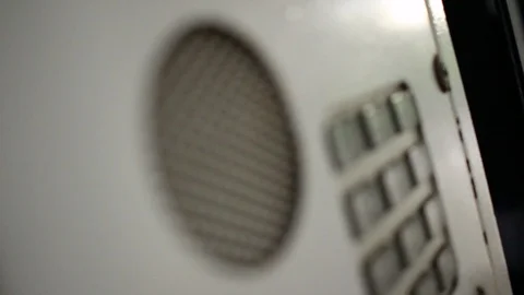 A closeup video of an intercom, with shallow depth of field. Stock Footage 92634067