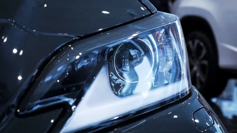 Closeup video left car headlight side span of the camera. Stock. Modern Video stock 130138870