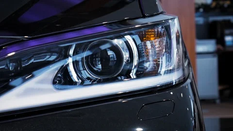 Closeup video left car headlight side span of the camera. Stock. Modern 스톡 동영상 130159621
