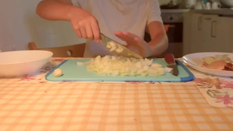 Closeup video of skillfully chopping onions on a blue board Stock Footage 318926897