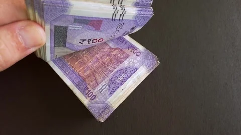 Closeup view of 100 indian rupee (INR) banknotes stack. Stock Footage 296844039