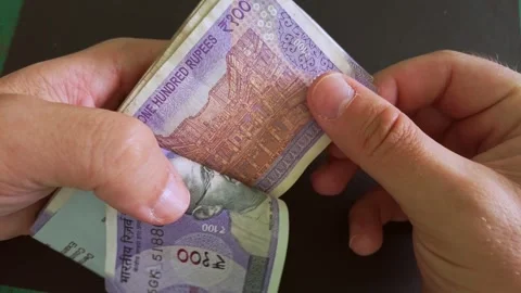 Closeup view of 100 indian rupee (INR) banknotes stack. Stock Footage 296844088