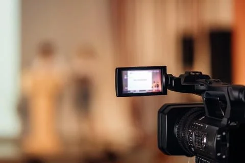 Closeup view of 4k broadcasting camera with external screen Stock Photos