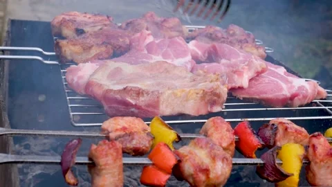 Closeup view 4k stock video footage of turning steaks of hot steaming meat on Stock Footage 237174525