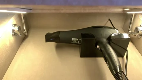 Closeup view 4k video of black hair dryer in the box in hotel Vídeo Stock 217435692