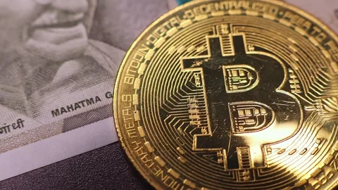 Closeup view of  500 indian rupee banknote and Bitcoin BTC coin. Stock Footage 286357411