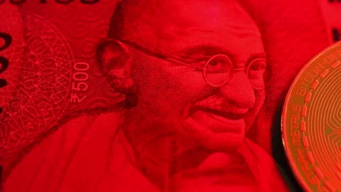 Closeup view of 500 indian rupee banknote and Bitcoin BTC coin. Stock Footage 286357821