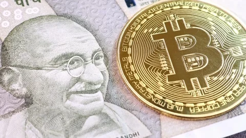 Closeup view of 500 indian rupee banknote and Bitcoin BTC coin. Stock Footage 286358490