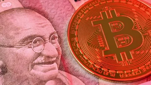 Closeup view of 500 indian rupee banknote and Bitcoin BTC coin. Stock Footage 286358538