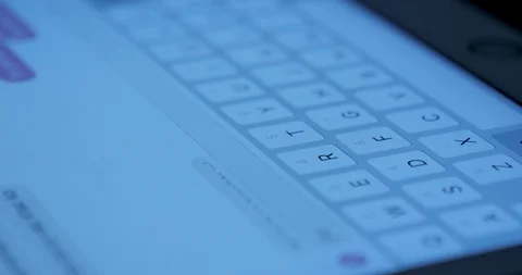 Closeup view adult using virtual keyboard on tablet device to send message on Stock Footage 95627172