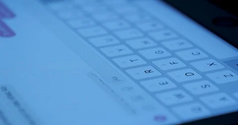 Closeup view adult using virtual keyboard on tablet device to send message on Stock Footage 95627332