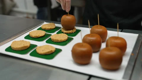 Closeup view of apples covered with caramel and sticks into them, delecious Stock Footage 230023167