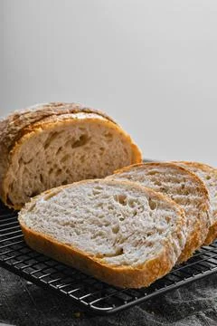 Closeup view of artisan whole grain wheat bread cut on slices on wooden table Stock-Fotos