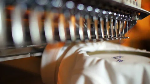 Closeup view of an automated embroidery machine working on a textile design Stock Footage 314376900