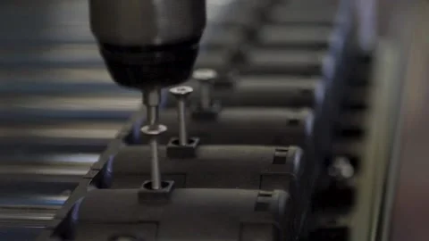 Closeup view of an automatic screwdrive screwing at a factory. Stock Footage 134696763