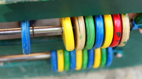 Closeup view of baby hands playing with colorful wooden circle toy outside on ki Stockbeeldmateriaal 117472002