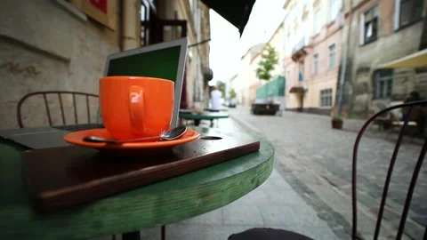 Closeup view of beautiful orange cup of tea coffee on the table with modern Video stock 163659267