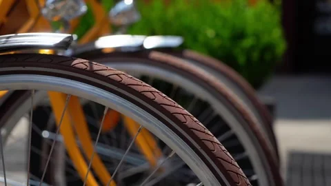 Closeup view of bicycle wheels captured in engaging urban setting for explorers 库存影片 291641815