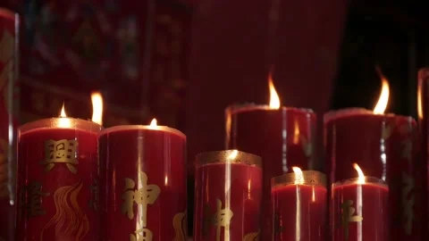 Closeup view, big burning red candles inside the Chinese temple Stock Footage 134178392