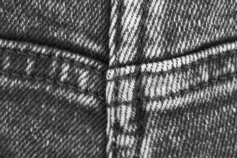 Closeup view of black denim fabric texture with visible stitching. Detailed.. Stock Photos