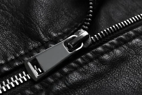 Closeup view of black leather jacket with zipper as background Stock Photos