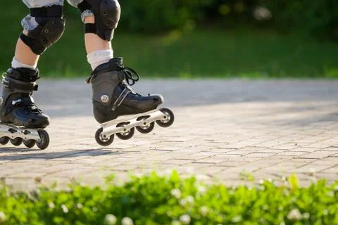 Closeup view of black roller skates or rollerblading. Roller skate legs of a  Stock Photos