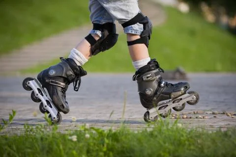 Closeup view of black roller skates or rollerblading. Roller skate legs of a  Stock Photos