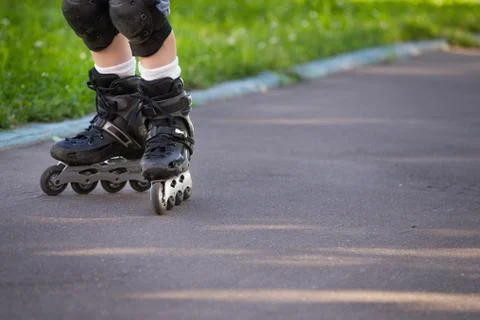 Closeup view of black roller skates or rollerblading. Roller skate legs of a  Stock Photos