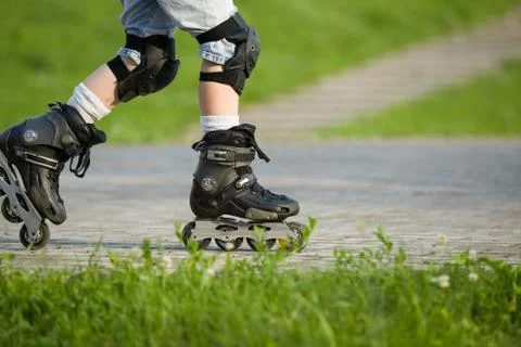 Closeup view of black roller skates or rollerblading. Roller skate legs of a  Stock Photos
