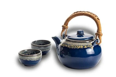 Closeup view of blue ceramic tea set with cups. Stock Photos