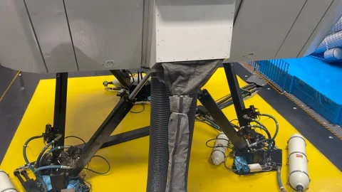 Closeup View of the Botton of an Old Fiull-Motion Flight Simulator Operating in Stock Footage 337588869