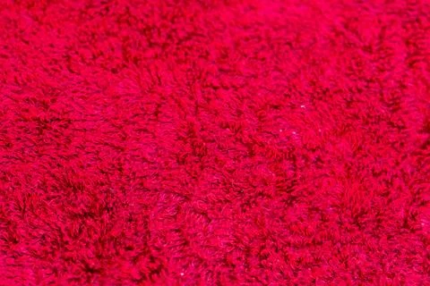 Closeup view of bright red fluffy carpet texture background surface 写真素材