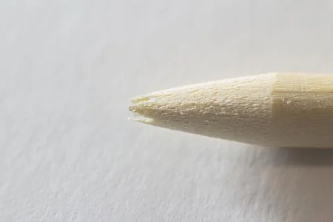 Closeup view of a broken pencil without lead rod on a white paper background Stock Photos
