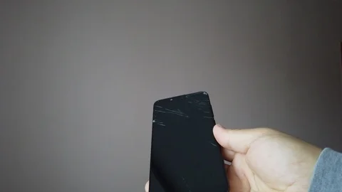 Closeup view of broken screen of black smartphone in hands of men Stock Footage 124734853