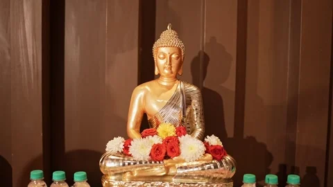 A closeup view of Buddha figurine or statue in lotus position worshiped wit.. Stock Footage 313258183