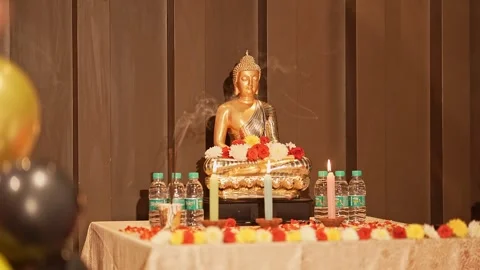 A closeup view of Buddha figurine or statue in lotus position worshiped wit.. Stock Footage 313258363