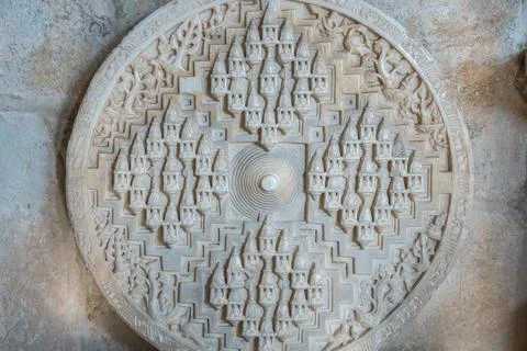 A closeup view of a buildings ceiling featuring a circular design with symmet Stock Photos