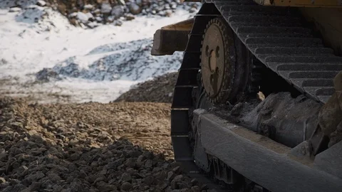 Closeup view of bulldozer moving at construction site of oil factory on winter Stock Footage 119402329