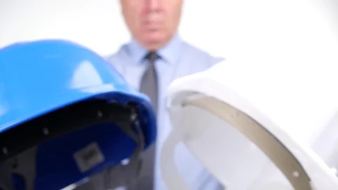Closeup View with Businessman Offering Engineer to Choose Between Two Helmets Stock Footage