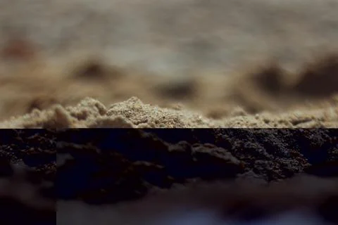 A closeup view captures the textures and grains of sand on a Greek beach Stock Photos