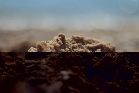 A closeup view captures the textures and grains of sand on a Greek beach Stock Photos