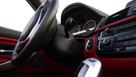 Closeup view of car interior showcasing steering wheel, dashboard and gear shift Stock Footage 319020602