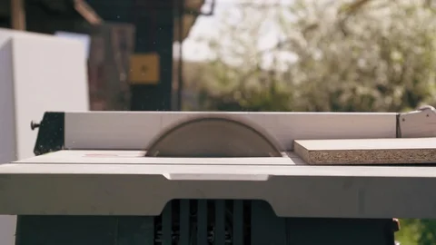 Closeup view of carpenter is using circular saw to cut wood boards. Slow motion Stock Footage 90099758